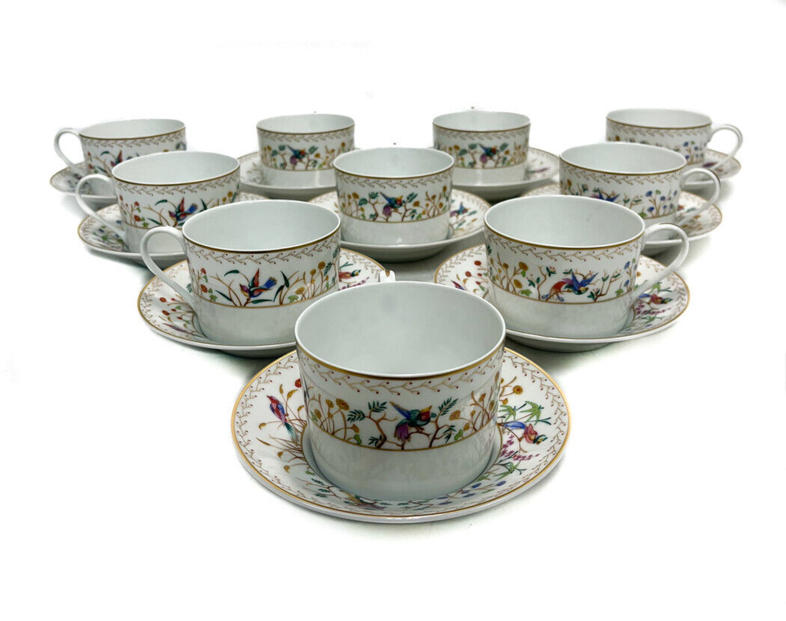 10 Tiffany Limoges Porcelain Audubon Cup and Saucers: 10 Tiffany & Co. porcelain cup and saucers in the Audubon pattern, made by Limoges. White ground with multi-color hand painted birds perched on branches. Tiffany & Co. Audubon mark to underside. Weigh