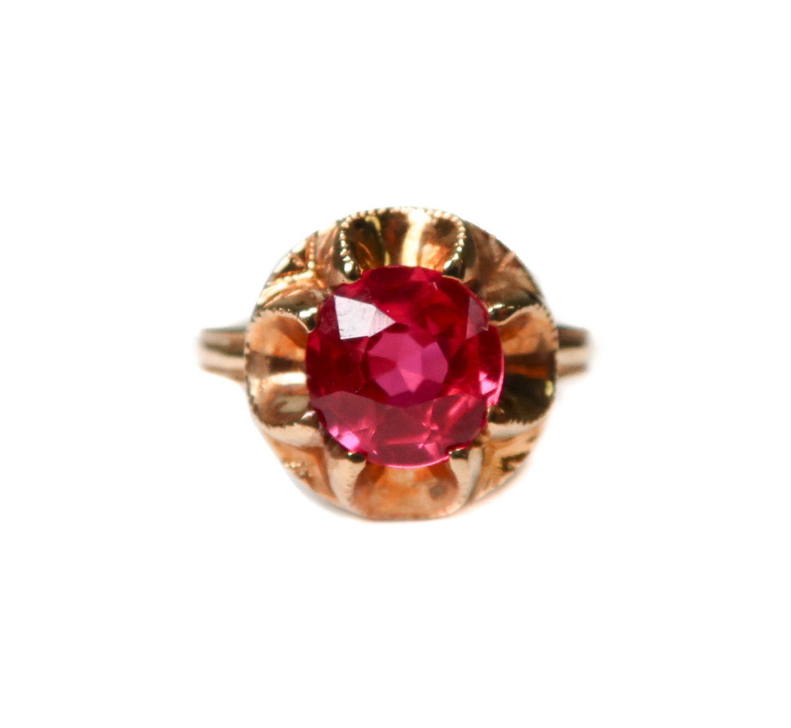 10k Yellow Gold Round Cut Red Sapphire Ring: 10k yellow gold round cut red sapphire ring. Beaded band and ruffled center. Marked 10k to the inner band. Weight Approx., 2 grams Measures Approx., Size 5.25 / Red Sapphire: 7.3mm diameter x 4.3mm Do