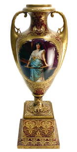 Royal Vienna Hand Painted Porcelain Double Handled Urn: Royal Vienna Austria hand painted porcelain double handled urn, circa 1900. A burgundy red ground wit gilt leaves and floral accents throughout. The central area depicts a hand painted partially noble