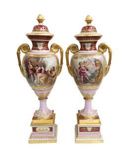 Pair Royal Vienna Hand Painted Porcelain Covered Urns, circa 1900: Pair Royal Vienna Austria hand painted porcelain double handled urns, circa 1900. A light pink and burgundy red ground with gilt leaves and floral accents throughout. The central of of one vase depict