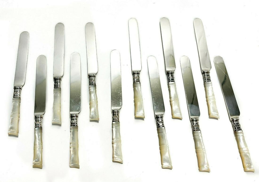12 Mother of Pearl Handled Knives: 12 American steel and Mother of Pearl fruit or dessert knives, circa 1920. Mother of Pearl carved to resemble bamboo. Silver plate ferrules, blades marked Duhme & Co. Cincinnati. With rolled flatware