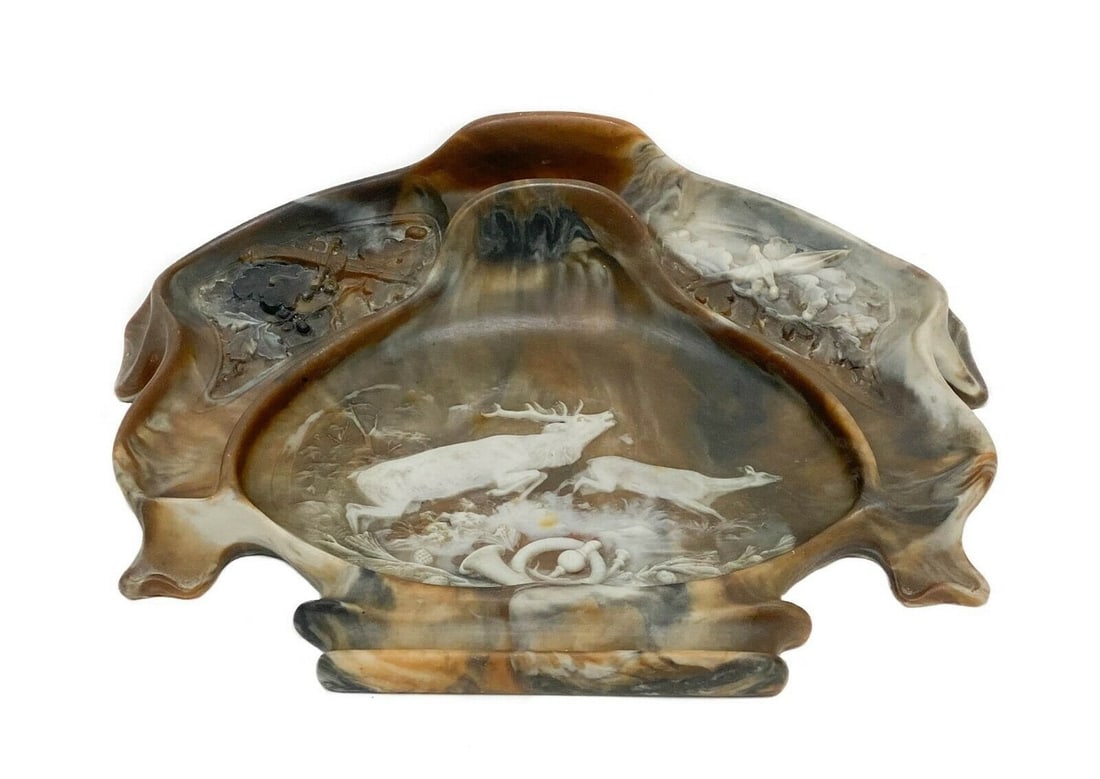 Composite Emulating Sardonyx Desk Pen Holder: Composite emulating sardonyx desk pen holder with a raised hunting scene depicting deer, daggers, and a French horn to bottom. Felt pads to underside. Weight Approx., 3 lbs Measures Approx., 11.25 inc