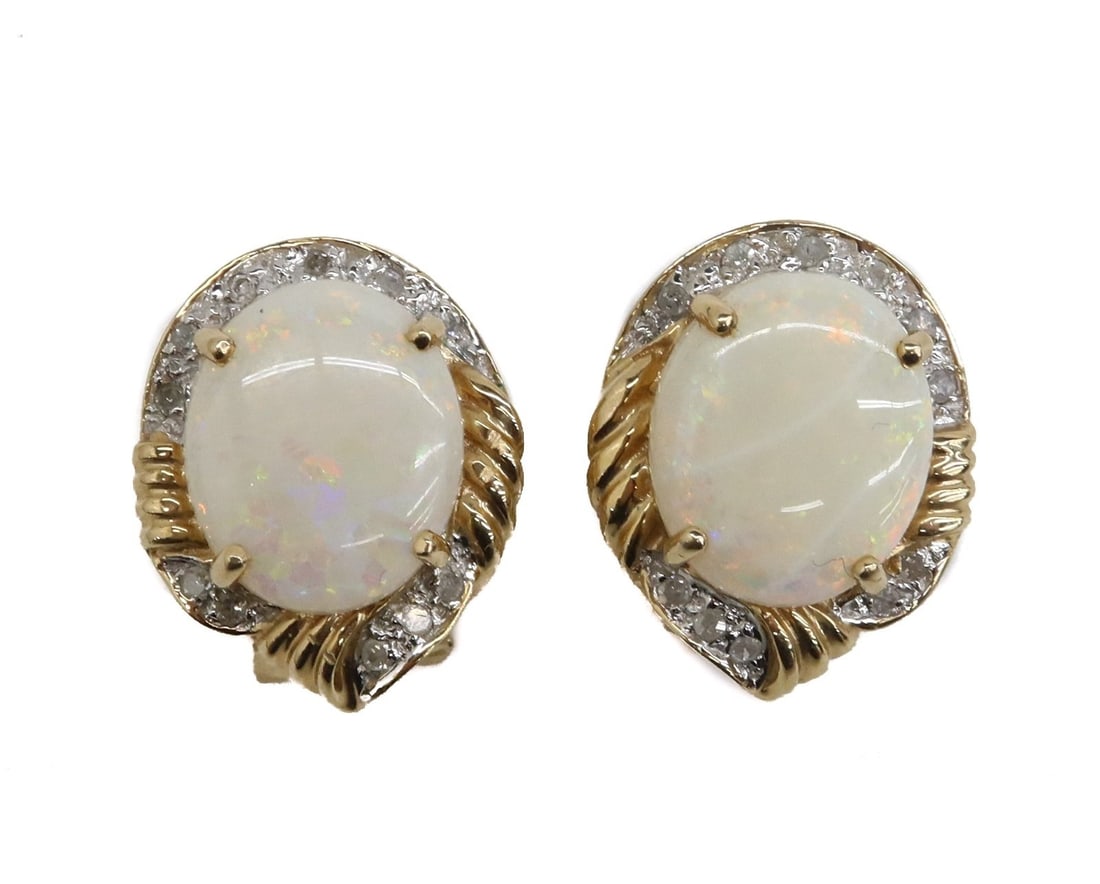 14k Yellow Gold White Opal and Diamond Earrings: 14k Yellow Gold White Gold and Diamond Earrings. Oval Cut White Opals with diamonds to the frame. Marked 14k to back. Weight Approx, 8 grams Measures Approx., 0.75 inches x 0.5 inches x 1 inch Domesti