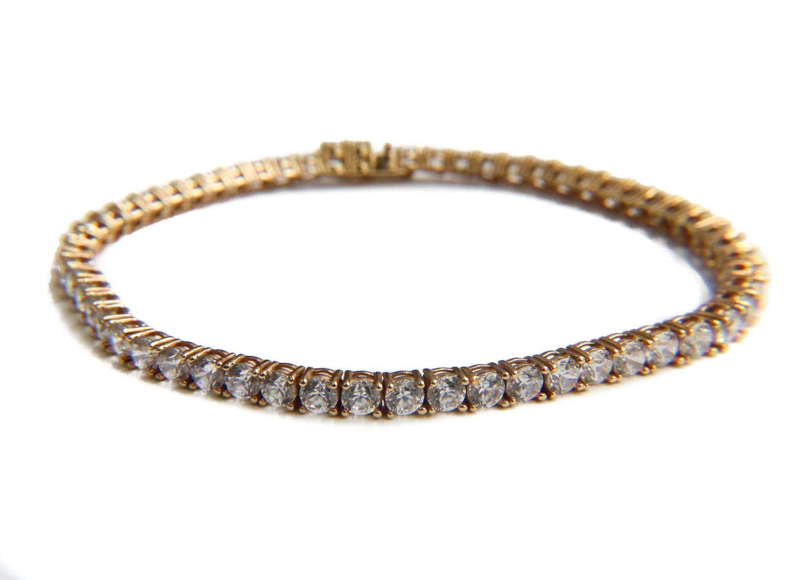 14k Yellow Gold and Quatz Tennis Bracelet: 14k Yellow Gold and Quatz Tennis Bracelet. 57 round cut quatz to strand. marked "14k" to clasp. Weight Approx., 7.61 grams Measures Approx., 6.75 inches length Domestic Shipping: $25