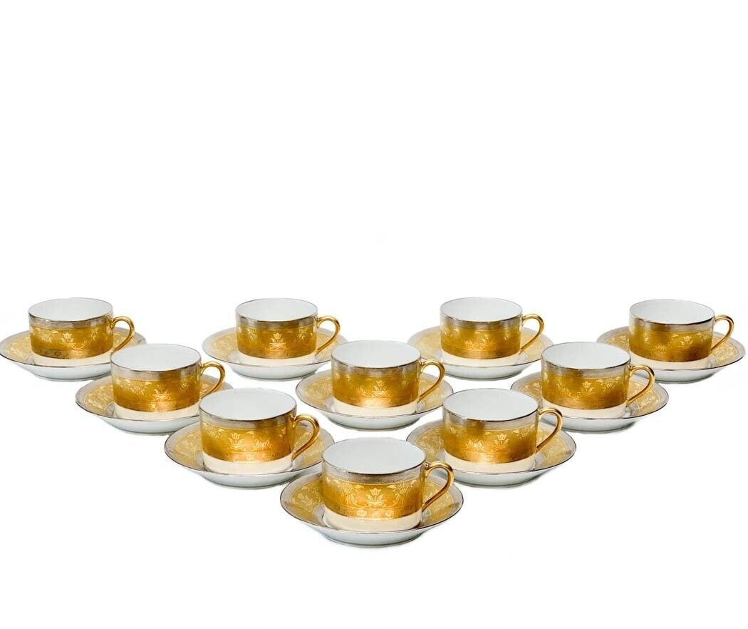 10 Christofle France La Paiva Gilt & Platinum Banded Porcelain Tea Cup & Saucers: 10 Christofle France porcelain tea cups and saucers in La Pavia. A white ground to center, gilt to the edge and with platinum bands to the rim with floral designs. Gilt to rims and handles. Each cup h