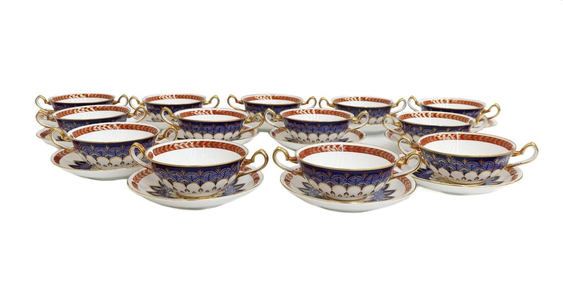 13 Royal Crown Derby Porcelain Bouillon Bowls and Underplates in Quail, 20th C: 13 Royal Crown Derby England porcelain bouillon bowls and underplates Quail, Late 20th Century. Rust red and gold feathered rim with a blue and gold blue quail feathered emblem to center. Royal Crown