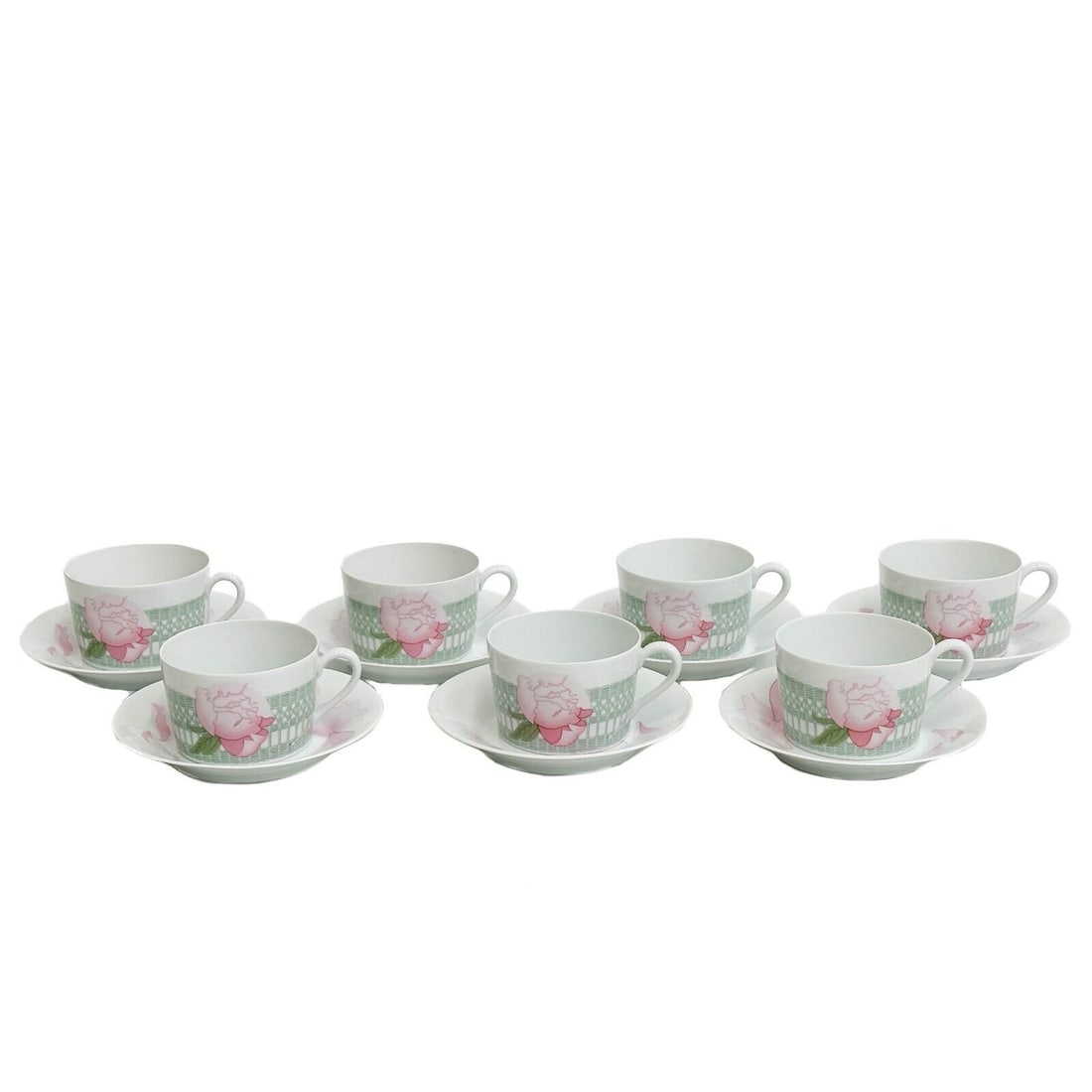 7 Hermes France Porcelain Tea Coffee Breakfast Cups Saucers Les Pivoines Pink: 7 Hermes France Porcelain breakfast Cups and Saucers in Les Pivoines. A white ground with ornate green basketweave decoration, pink flowers. Underside with Hermes marks. Weight Approx., 5 lbs Measures