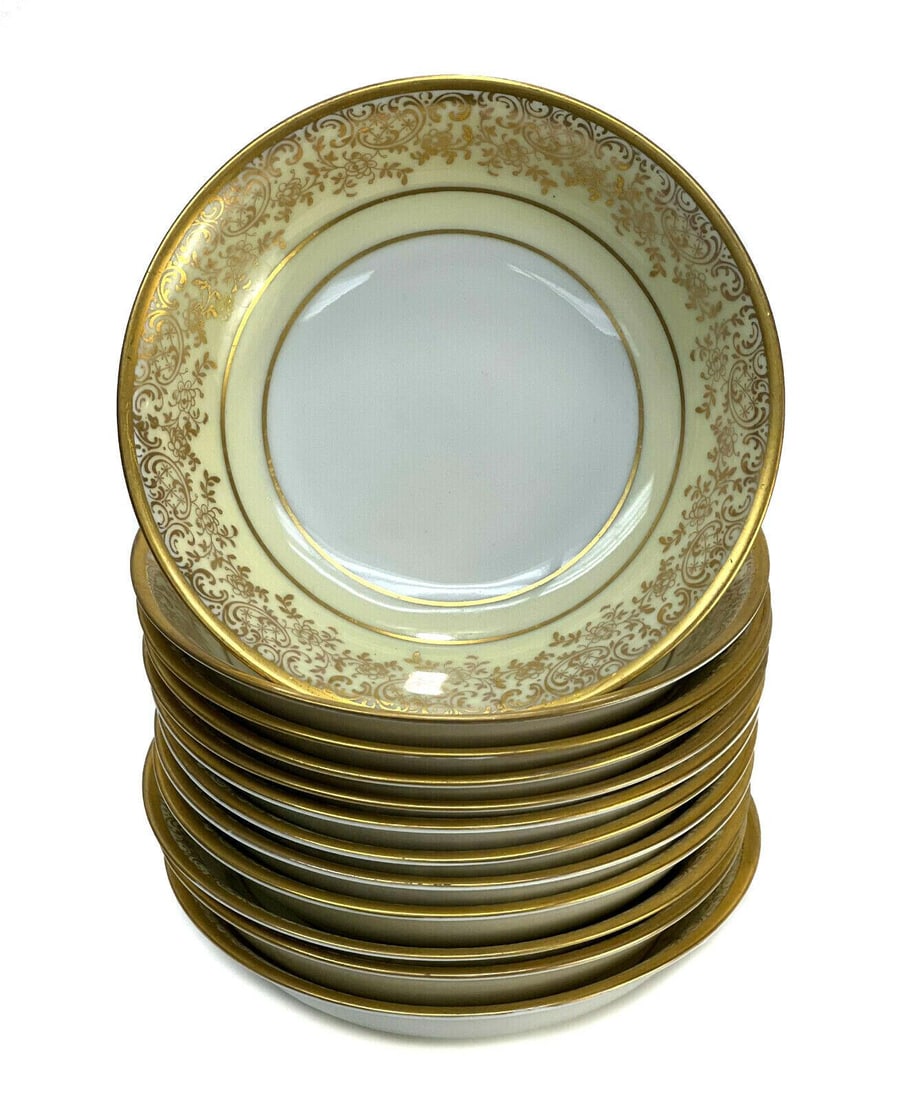 12 Hutschenreuther and Heinrich & Co. Porcelain Berry Bowls, circa 1930: 12 Hutschenreuther and Heinrich & Co. Bavaria porcelain berry bowls, circa 1930. White and pale yellow ground with gilt foliate scroll and floral decoration. Hutschenreuther and Heinrich & Co. mark to
