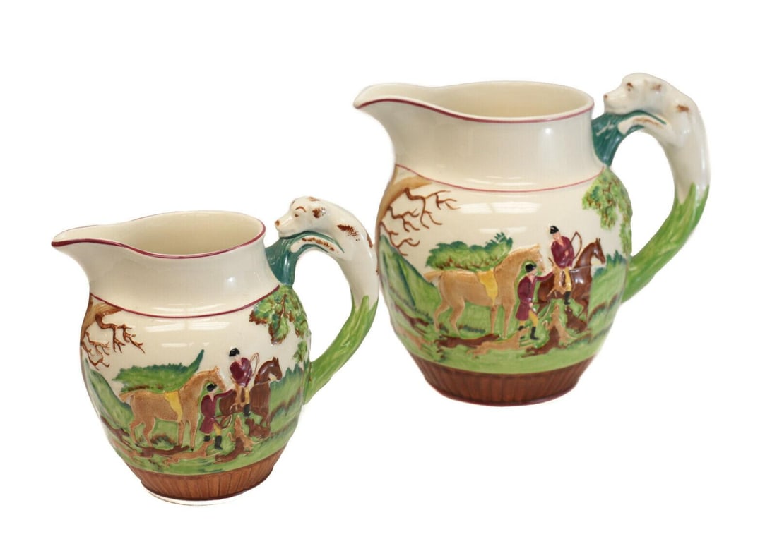 Pair Wedgwood Etruria Dye Ken John Peel Porcelain Pitchers. Hunting Scenes: Pair Wedgwood Etruria Dye Ken John Peel hand painted porcelain pitchers. Charming hand painted dog hunting scenes throughout and a figural dog to the handles. Wedgwood marks to the underside. Weight A