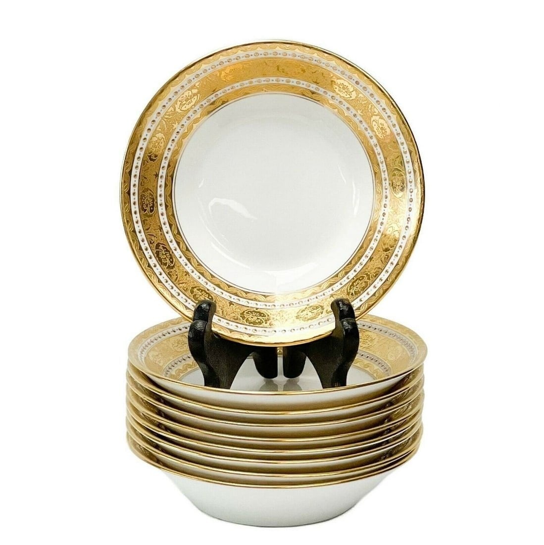 9 Minton England Gilt Porcelain Berry Bowls in H1417, 1910: 9 Minton England gilt porcelain berry bowls in H1417, 1910. A white ground to the center, ornate gilt decoration to the edge featuring florals and twisted ribbons. Bands of raised gilt dot decoration.