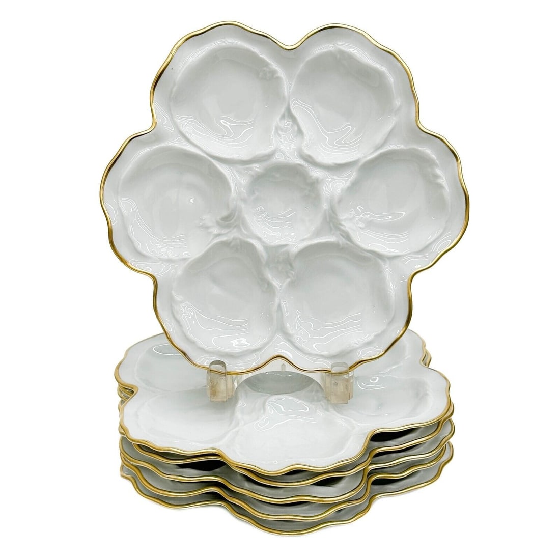 6 Limoges France Gilt Porcelain Oyster Plates White circa 1950: 6 Limoges France Gilt Porcelain Oyster Plates, circa 1950. White porcelain plates, gilt to the scalloped rims. Underside marked Limoges France Weight: Approx. 7 lbs Measurements: Approx. 10 inches dia