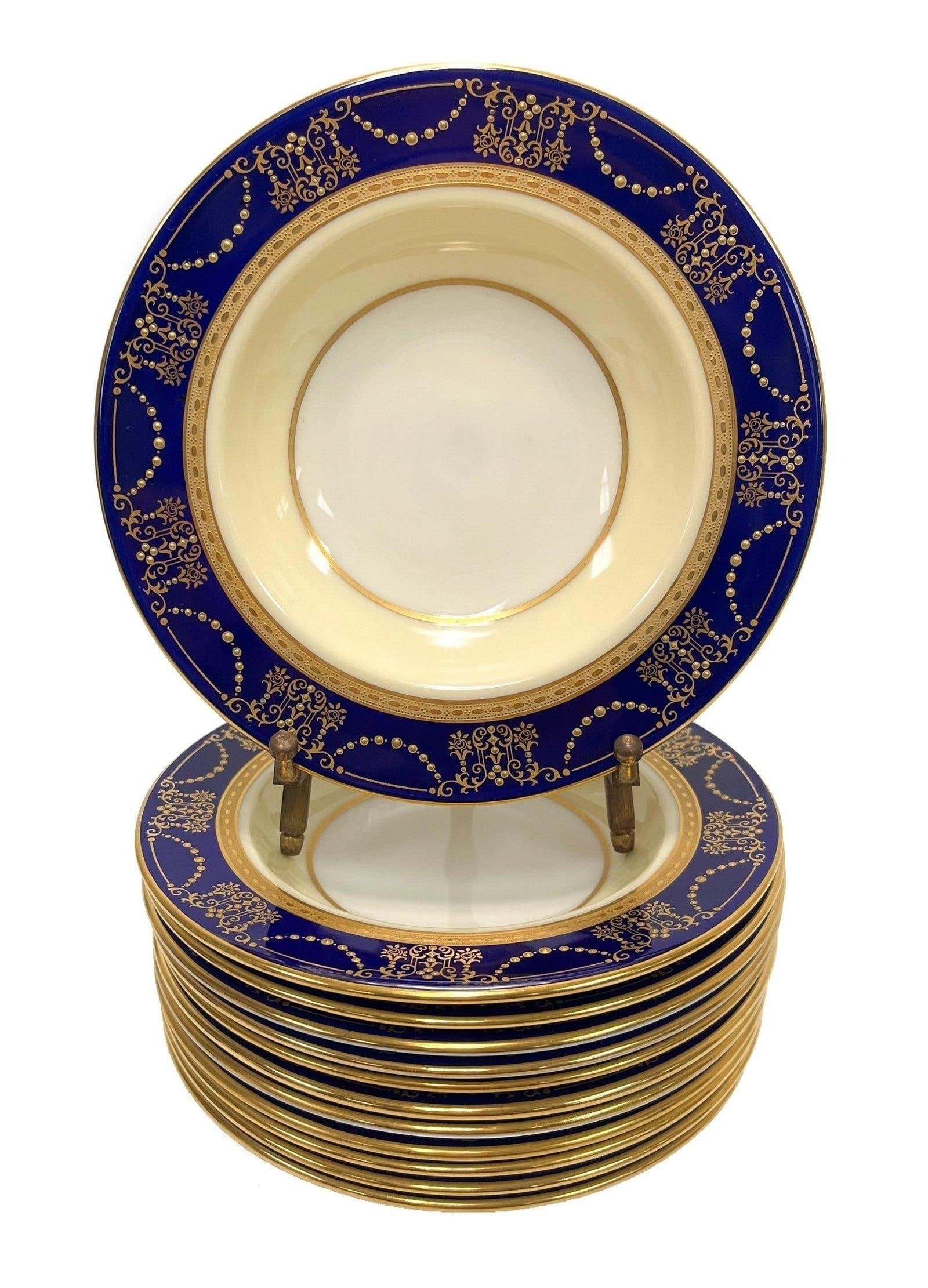 12 Lenox Porcelain Berry Bowls, circa 1920: 12 Lenox Porcelain Berry Bowls, circa 1920. Cobalt blue band around the rims with raised gilt swags and floral bouquets. Lenox porcelain marks to the underside. Measures Approx., Berry Bowls: 6.25 inc