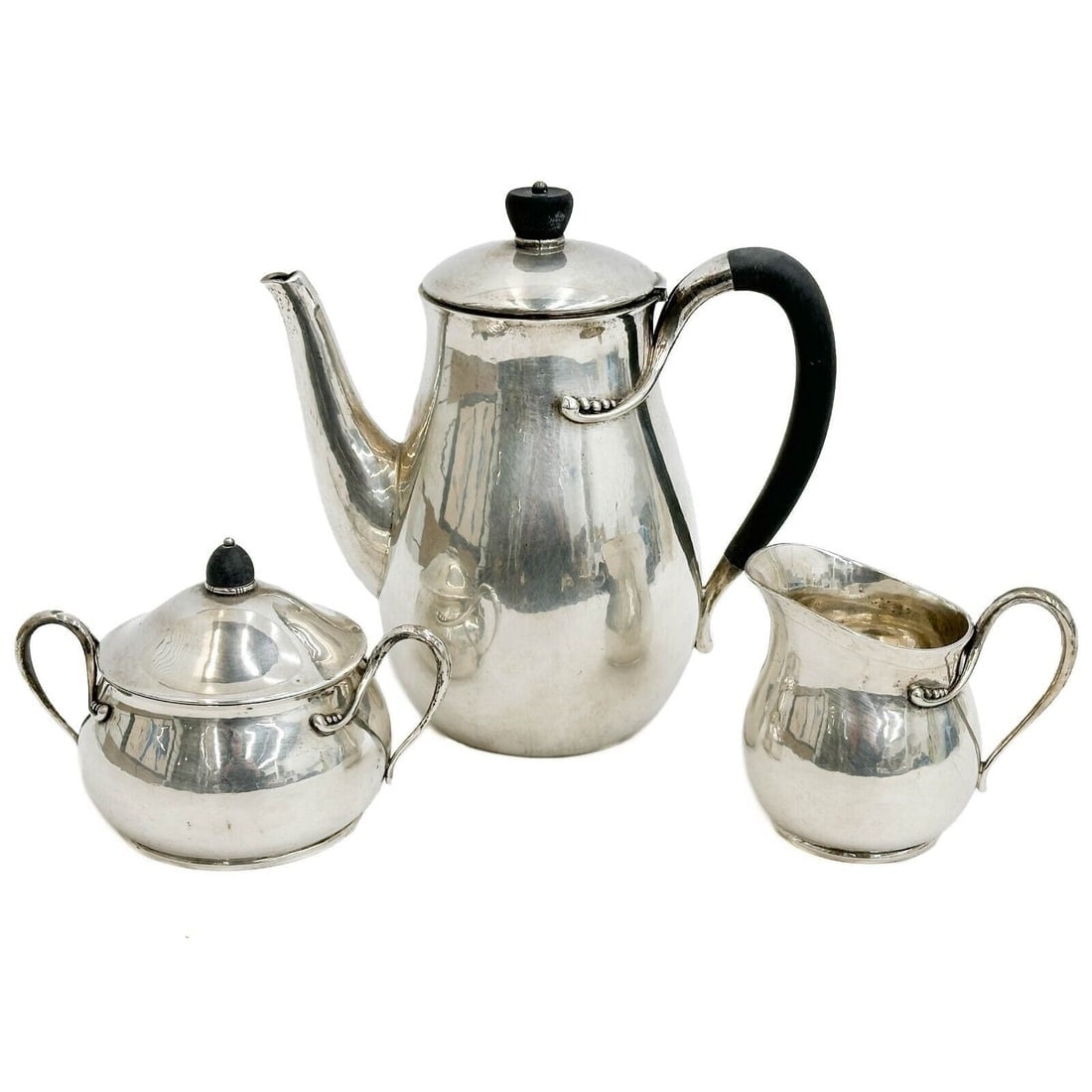 Modernist 3pc Evald Nielsen Denmark Silver Coffee Service Set circa 1940: Modernist 3 piece Evald Nielsen silver coffee service set, c1940. The service includes coffee maker, cream and sugar bowl with lid. Wood accents, blossom beads. Marked Evald Nielsen to the underside.