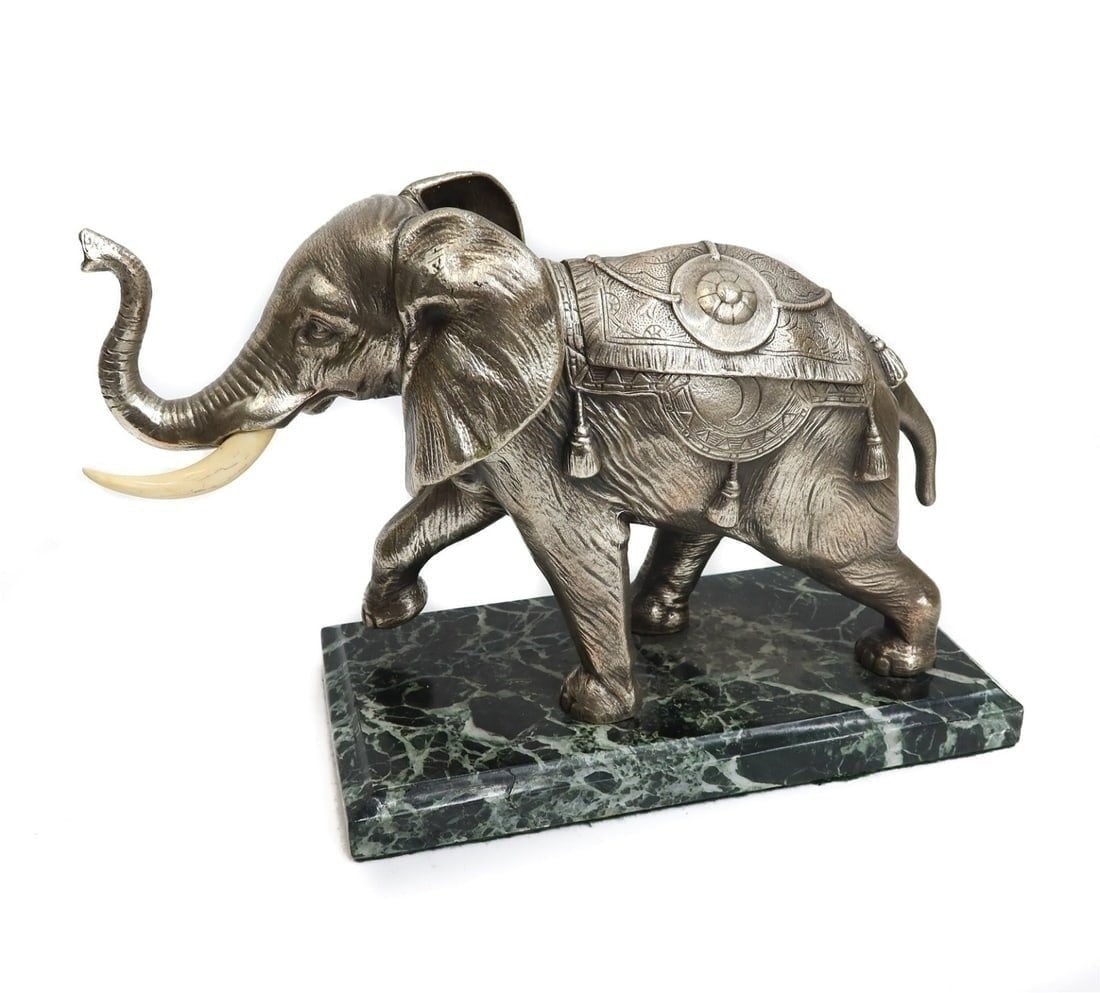 French Silvered Bronze Elephant Inkwell: A novelty French Inkwell realistically modeled silvered bronze Elephant on black carrara marble base. The Indian inspired saddle bag opens to reveal dual inkwells, with carved bone tusks. 1st half 20t