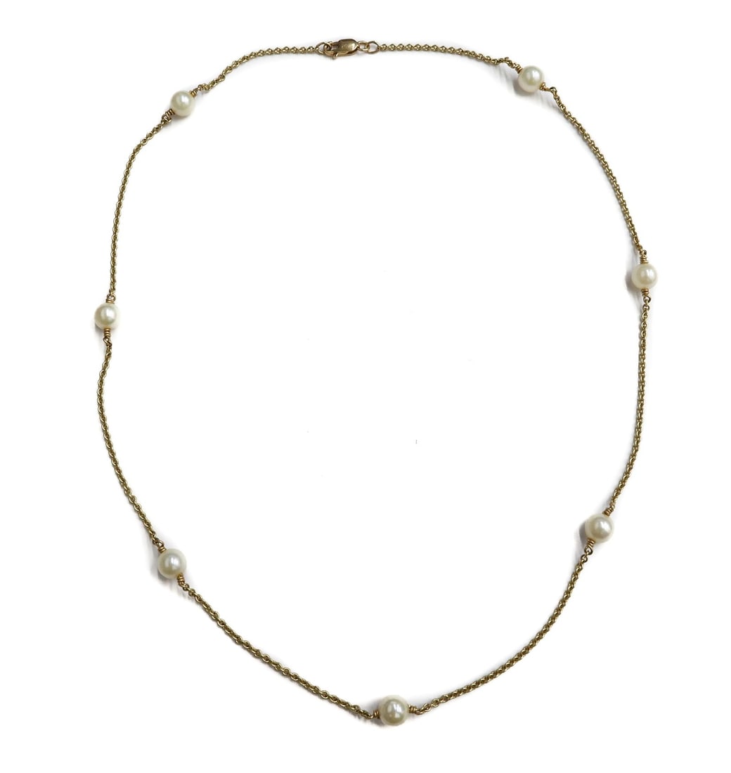 14k Yellow Gold Cultured Pearl Necklace: 14k Yellow Gold Cultured Pearl Necklace. 7 Cultured pearls to gold strand measuring approxinately 5.7 mm. Marked 14k to clasp. Weight Approx., 5.14 grams Measures Approx., 17inches length Domestic Shi