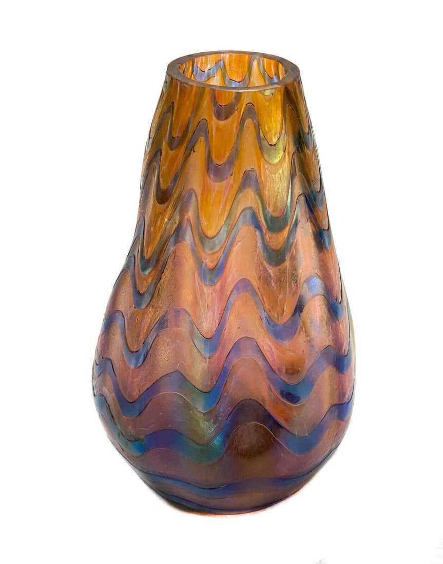 Austrian Iridescent Art Glass Two Color Amethyst and Orange Swagged Vase: Austrian iridescent art glass two color amethyst purple and orange swagged vase. Unmarked, but possibly Loetz. Weight: Approx. 1 lbs Measurements: Approx. 3.5 inches diameter x 5.75 inches tall Domest