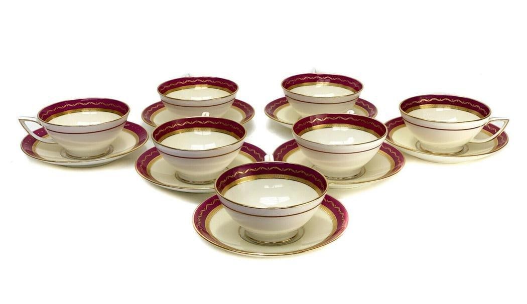7 Minton England Porcelain Cup and Saucers, circa 1900. Maroon and Gilt: 7 Minton England Porcelain Cup and Saucers, circa 1900. A maroon red ground. Gilt beaded design with waves around the edge. Minton England porcelain marks to the underside base. Weight Approx., 3 lbs