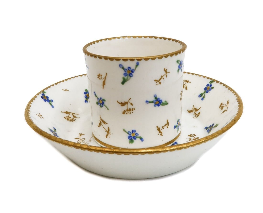 Sevres Porcelain Factory Hand Painted Floral and Gilt Cup and Saucer 1788: Sevres Porcelain Factory hand painted floral and gilt cup and saucer, 1788. Gilt and hand painted blue floral sprigs throughout. with gilt to rims. Sevres Porcelain Factory mark to underside with LL f
