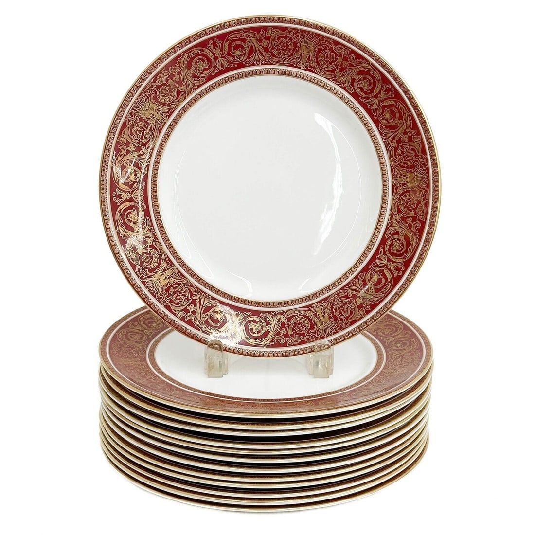 12 + 1 (13) Royal Doulton England Porcelain Dinner Plates in Buckingham Red: 13 Royal Doulton England Porcelain dinner Plates in Buckingham, mid century. A maroon ground with ornate gilt foliate deocration. Underside marked Royal Doulton England Buckingham. Weight: Approx. 15
