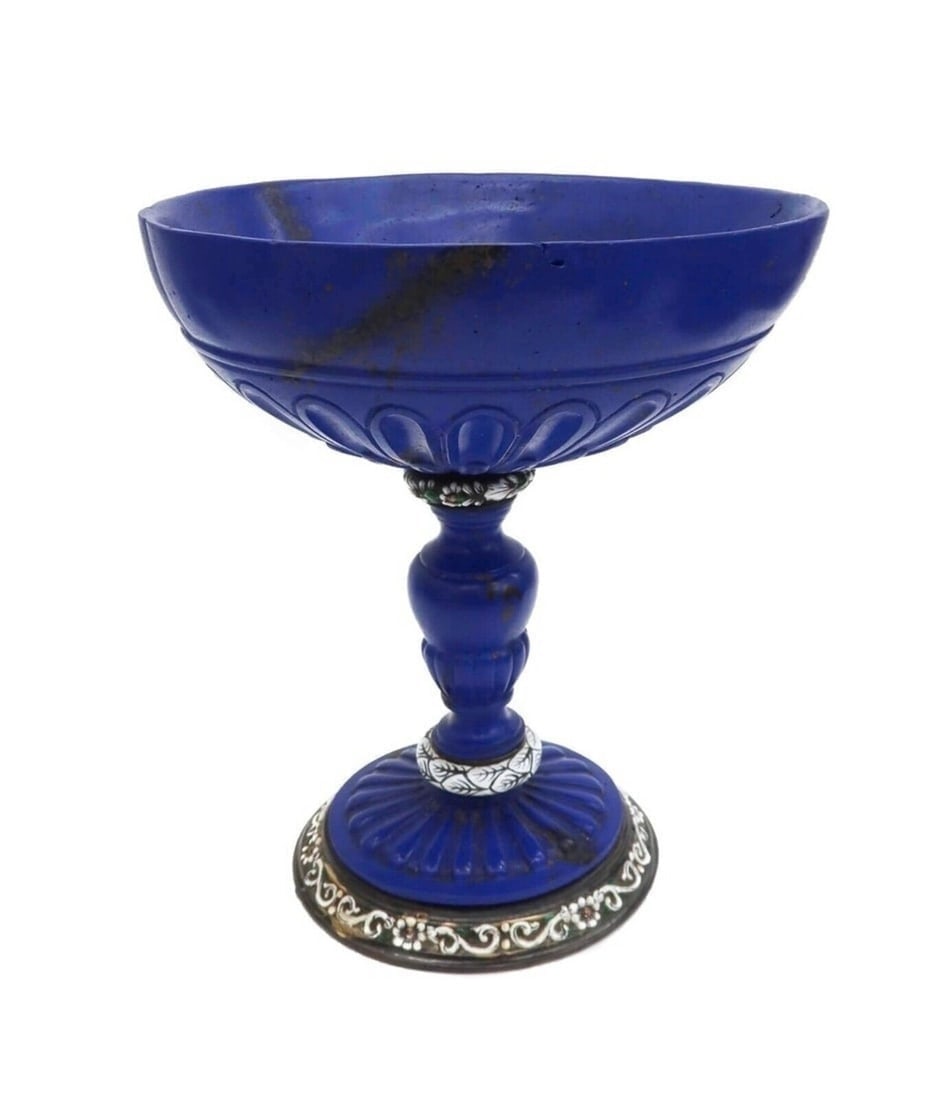 German Enamelled Silver Mounted Lapis Lazuli Chalice, 19th Century: German enamelled gilt silver-mounted lapis lazuli chalice, 19th Century, in the manner of Reinhold Vasters. Oval carved with a lobed pattern above baluster stem. White leaf enamel to circular bands wi