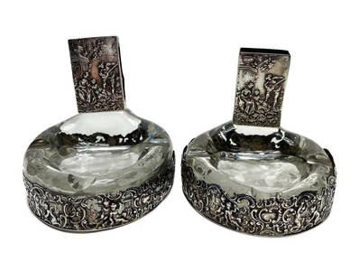 Pair German 800 Silver Overlay Glass Ashtrays and Match Box Horseshoe: Pair Bucholz & Zelt German 800 silver overlay and glass ashtrays and match box horseshoe, circa 1900. A novelty pair with equestrian themed pierced figures throughout the exterior. Bucholz & Zelt 800
