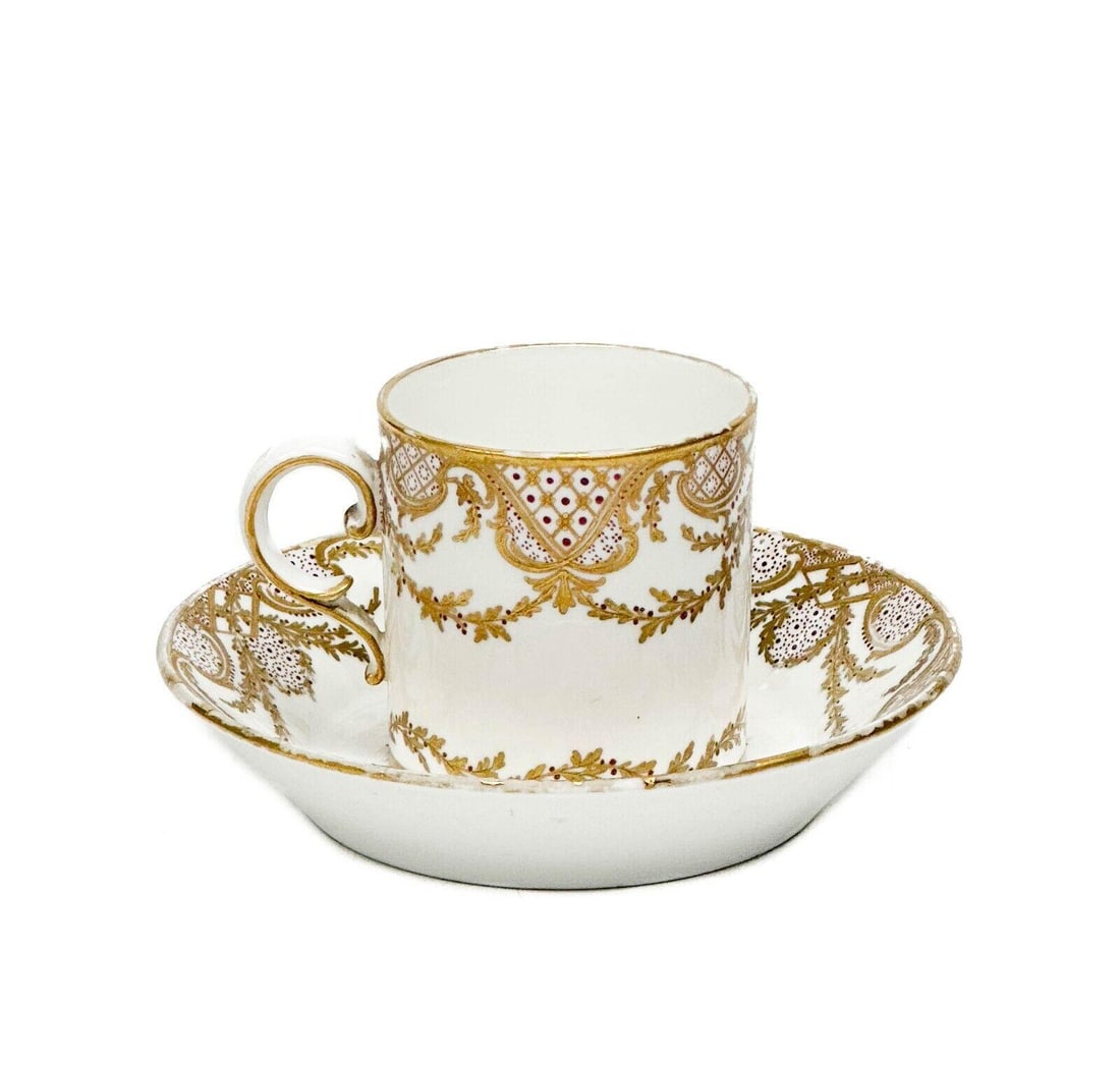 Sevres White & Gilt Porcelain Cup and Saucer 1756-7 by Vincent: Sevres gilt porcelain cup and saucer, 1756-7. A white ground with ornate gilt floral decoration, red designs. Underside with Sevres marks, artist's mark VC for Vincent I, recorded as a painter for Sev