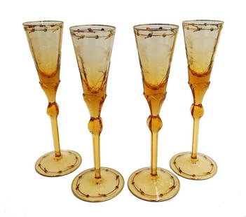 4 Moser Czech Cut Crystal Glass Champagne Flutes in Paula Amber Orange and Gilt: 4 Moser Czech cut crystal glass champagne flutes in Paula Amber Orange and Gilt. Gilt intaglio engraved floral decoration to rim and foot. Multi-sided knobbed stem. Acid etched "Moser" to base. Weight