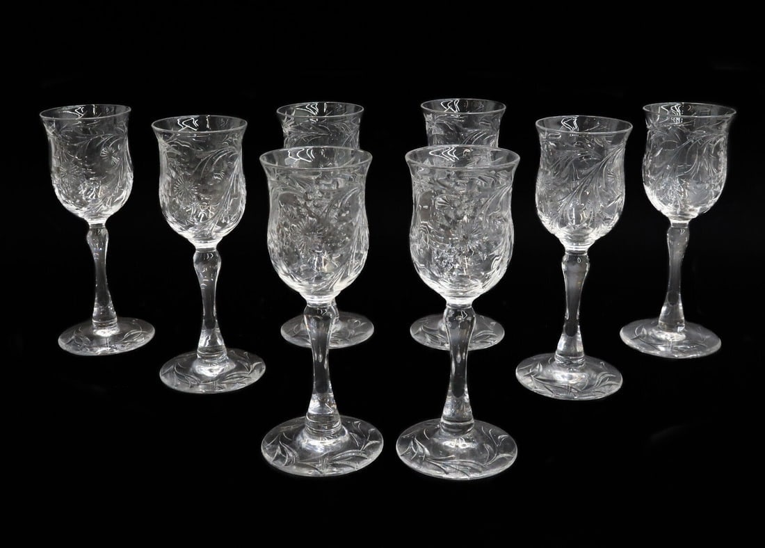 8 Webb Corbett Cut Glass Wine Goblets in WEC84: 8 Webb Corbett Cut Glass Wine Goblets in WEC84. Etched florals and foliate scrolls to bowl with a leaf base. Weight: Approx. 2 lbs Measurements: Approx. 2.125 inches diameter x 5.75 inches tall Domest
