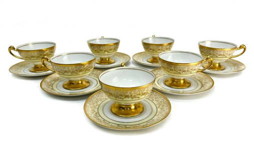 7 Hutschenreuther and Heinrich & Co. Porcelain Tea Cups, circa 1930: 7 Hutschenreuther and Heinrich & Co. Bavaria porcelain tea cups and saucers, circa 1930. White and pale yellow ground with gilt foliate scroll and floral decoration. Hutschenreuther and Heinrich & Co.