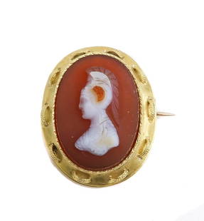 14k Yellow Gold Carved Hardstone Pin: 14k Yellow Gold Carved Hardstone Pin. The center depicts a hand carved portrait of an antiquity soldier. Tests for 14k yellow gold. Weight Approx., 5.12 grams Measures Approx., 1.25 inch x 1 inch Dome