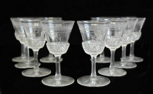 10 Continental Cut Glass Cordial Wine Glasses: 10 Continental cut glass cordial wine glasses. Acid etched laurel leaves towards the top rim of the glasses with an indistinguishable monogram to the center. Finely cut diamond spike texture designs t