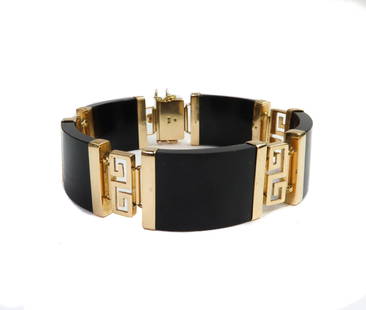 14k Yellow Gold and Black Jade Link Bracelet: 14k Yellow Gold and Black Jade Link Bracelet. 5 black jade links measuring approximately 6.1mm x 12.2mm x 3.6mm each with gold Greek key symbols to spacers. Marked 14k to clasp Weight Approx., 35.34 g