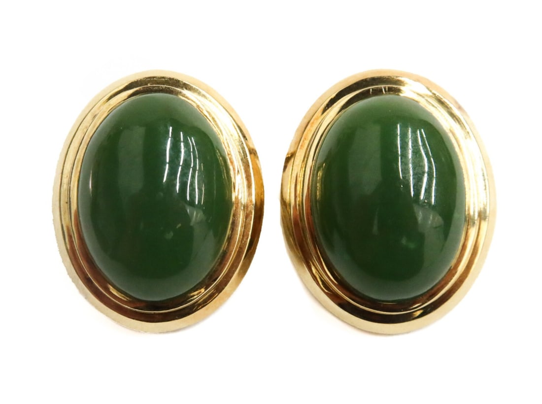 Pair Gump's 18k Yellow Gold Oval Cabochon Jade Clip on Earrings: Pair Gump's 18k Yellow gold oval cabochon jade clip on earrings. The jade measuring approximately 15.8mm x 11.8mm x 5.5mm. Marked Gump's 18k. Weight: Approx. 12.5 grams Measurements: Approx. 0.75 inch