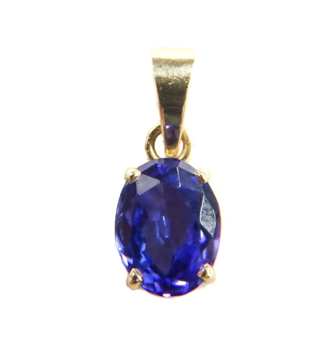 18k Yellow Gold Tanzanite Necklace Pendant: 18k Yellow Gold Tanzanite Necklace Pendant. Oval faceted tazanite center weighing approximately 1.97 carats. Marked 18k to hook. Weight Approx., 1.66 grams / Measures Approx., 1.4 inches / Tanzanite: 