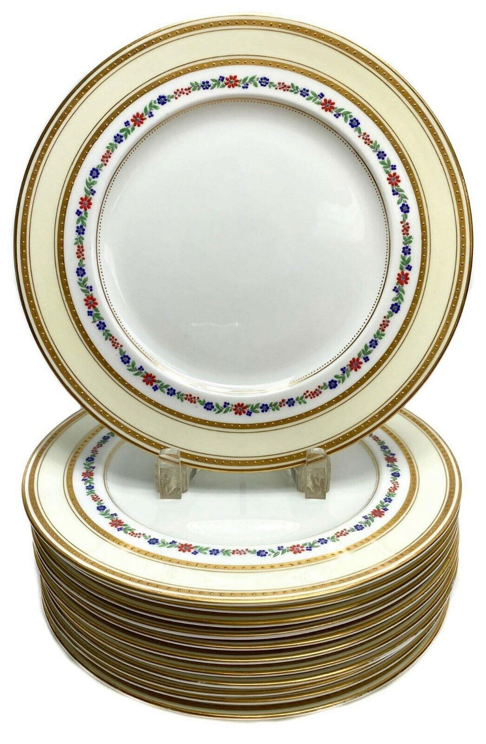12 English George Jones Crescent Dinner Plates with Enamel Flower Band c1920: 12 George Jones & Sons Crescent dinner plates with cream colored ground and colorful enamel floral band and gilt band around rim. George Jones Crescent mark to underside. Weight Approx. 16 lbs Measure