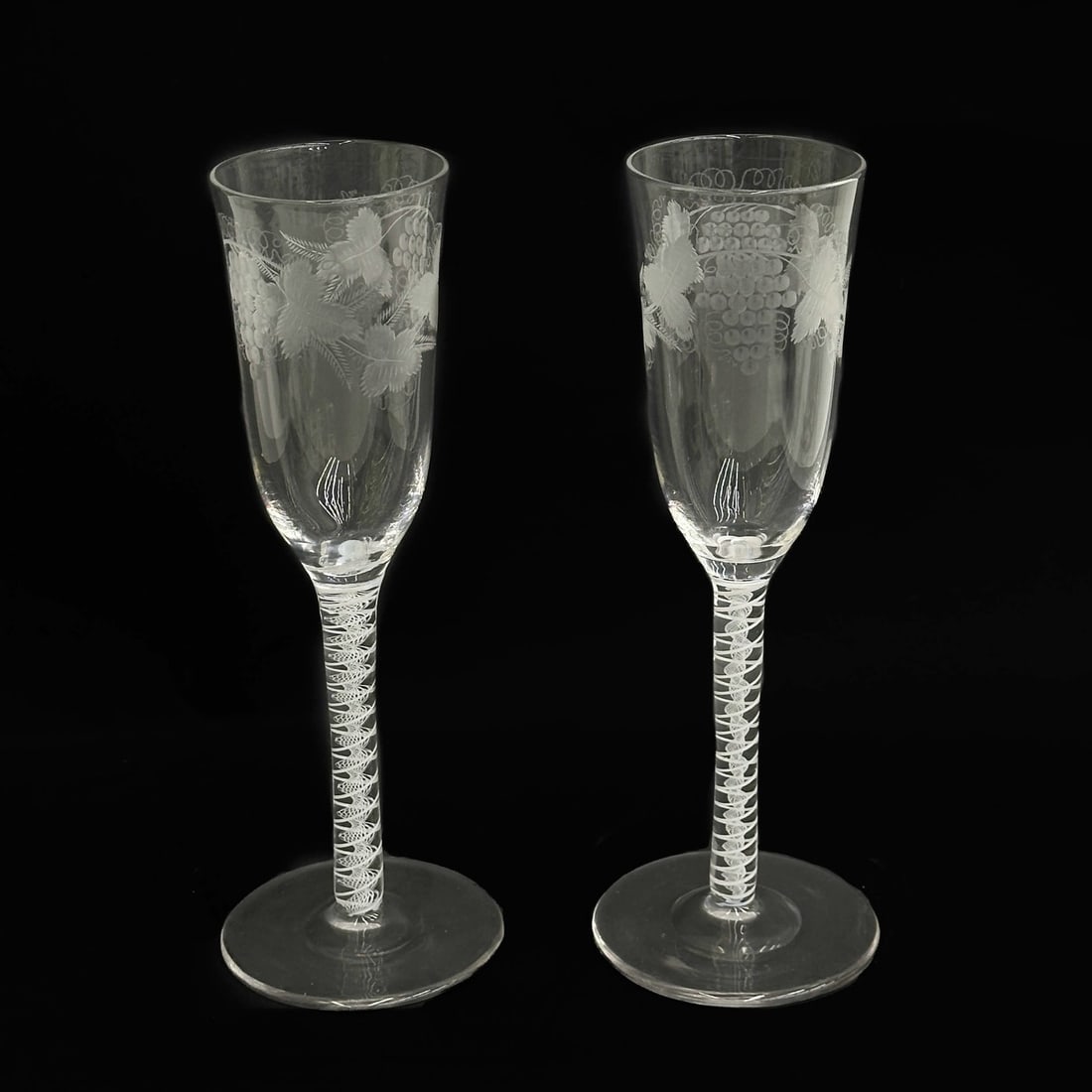 Pair English Air Twist Glass Engraved Grapevine Champagne Flutes 19th cen: Pair English Air Twist Engraved Champagne Flutes Glasses, 19th century, possibly earlier. Engraved grapevine decoration to bowl, air twist stems. Polished pontil Weight: Approx. 1 lb Measurements: App