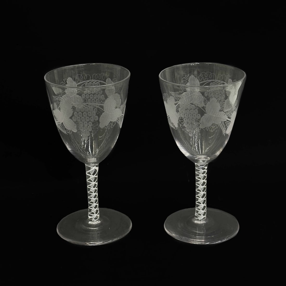 Pair English Air Twist Engraved Grapevine 5.5 in Wine Glasses 19th century: Pair English Air Twist Engraved Glasses, 19th century, possibly earlier. Engraved grapevine decoration to bowl, air twist stems. Polished pontil to the underside. Weight: Approx. .5 lb Measurements: A