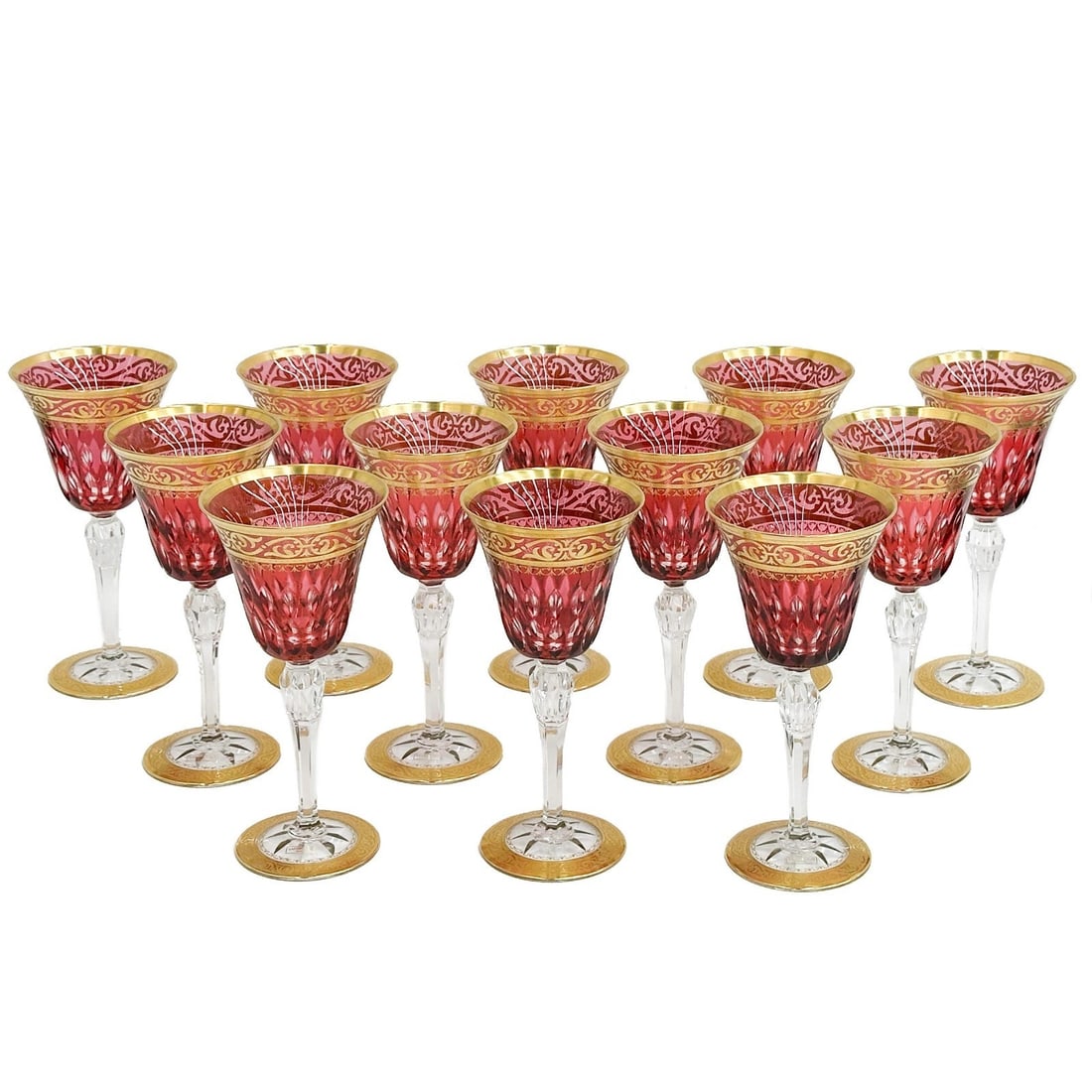 12 Saint (St.) Louis France Red Cut to Clear Glass Water Goblets Stella Gold: 12 Saint-Louis France Red cut-to-clear glass Water Goblets in Stella (Gold Encrusted). Red cut to clear bowls with ornate gilt decoration to the rim, a star cut foot. Acid-etched St Louis stamp to the