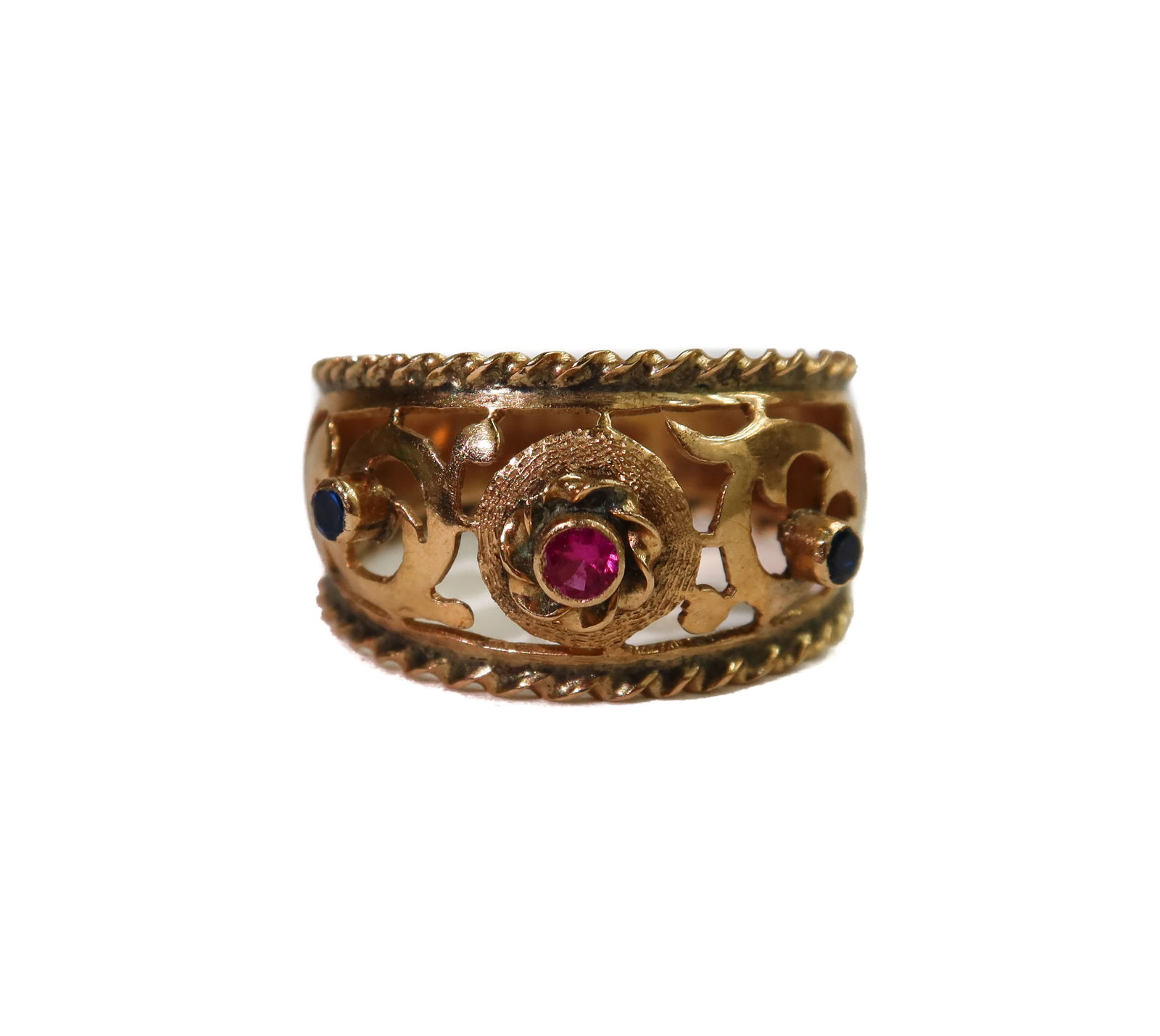 14k Yellow Gold Ruby and Spinel Filigree Ring Size 7.25: 14k Yellow Gold Ruby and Spinel Filigree Ring Size 7.25. Pierced Filigree thick gold band with a round cut ruby to center and two smaller blue spinels to either size. Tests for 14k gold. Weight Approx