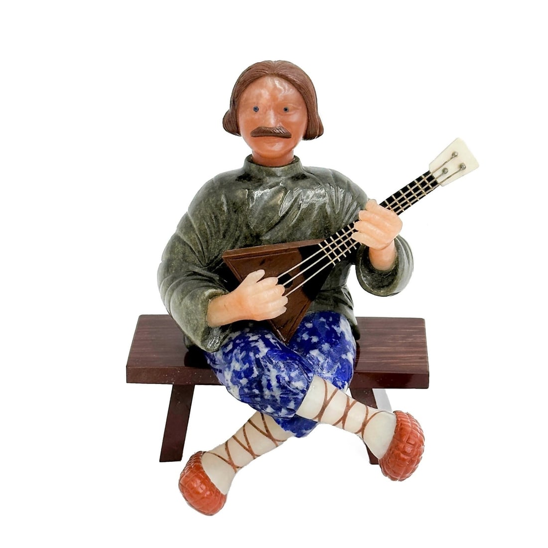 Gunther Petry (German b. 1939) Carved Mixed Stone Balalaika Player on Bench: Carved Mixed Stone Balalaika Player on Bench. Depicts a musician playing a balalaika seated on removable bench. Carved brown obsidian, labradorite, hardstone, quartz, sodalite, and jasper. 14k gold St
