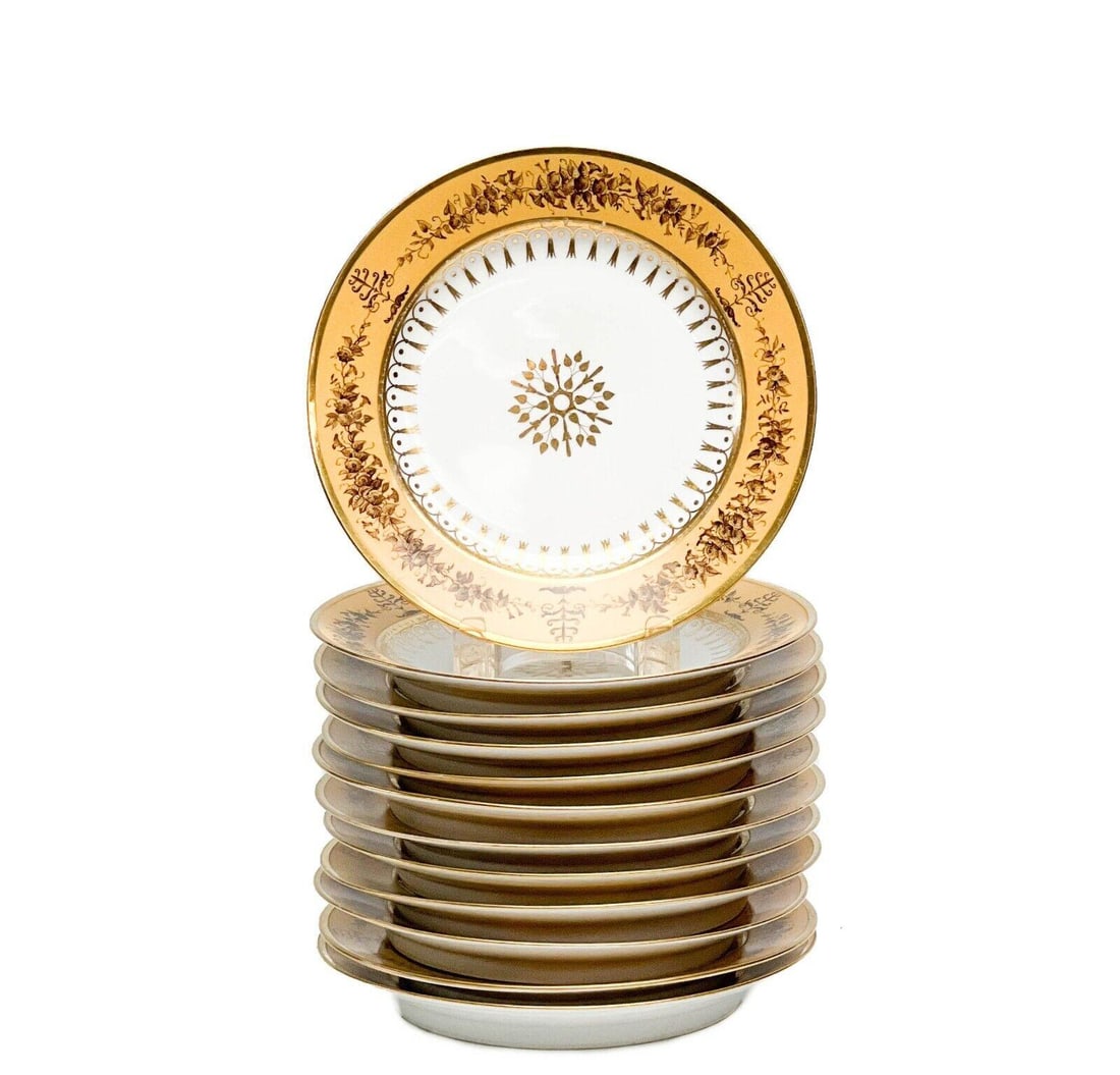 12 Manufacture de Sevres Gilt Porcelain Dessert Plates Nankin Yellow 1815-1824: 12 Manufacture de Sevres porcelain dessert plates, 1815-1824. A white ground to center, a nankin yellow ground to the edge with brown painted roses. Gilt snowflake/flower decoration to the center, gil