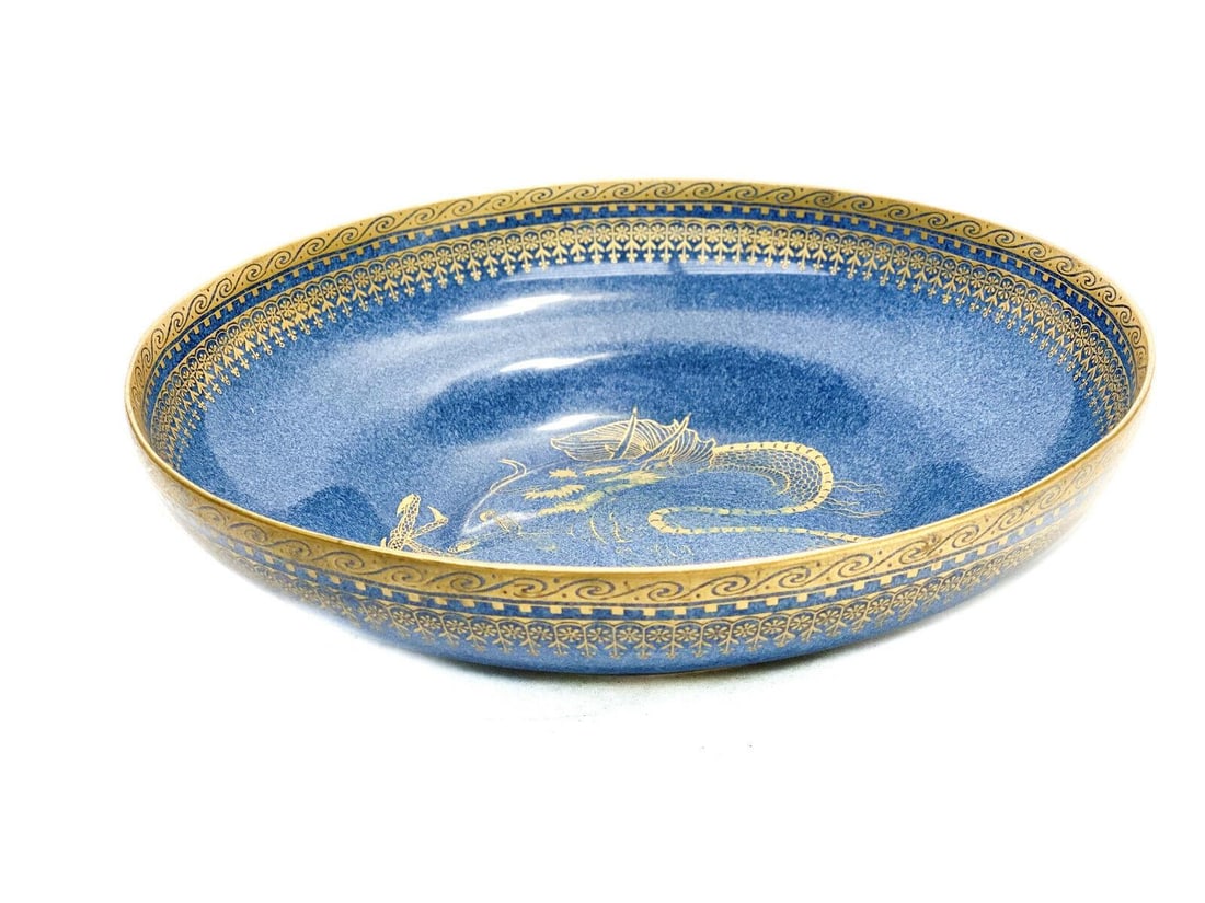 Royal Worcester England Powered Blue Porcelain Gilt Dragon Bowl, 1918: Royal Worcester England powered blue porcelain gilt dragon bowl, 1918. A powered blue periwinkle ground with a figural gilt dragon to the center. Gilt waves and flowers around the rim. Royal Worcester