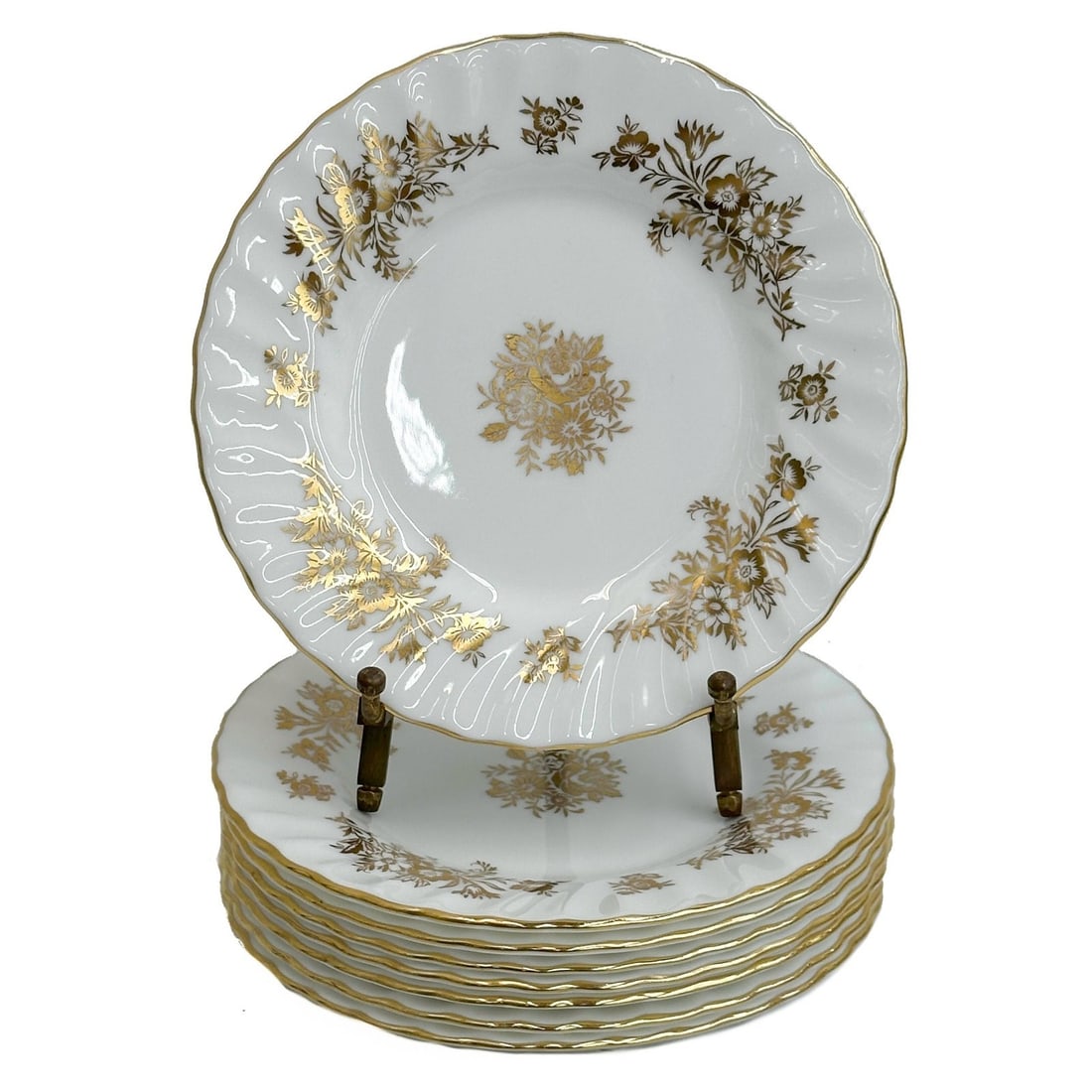 8 Minton England Gilt Porcelain Bread Plates H5017 circa 1955: 8 Minton England Gilt Porcelain Bread Plates in H5017. A white ground decorated with gilt florals, scalloped textured edge. Underside with Minton marks, date codes for 1950-1957 Weight: Approx. 3 lbs