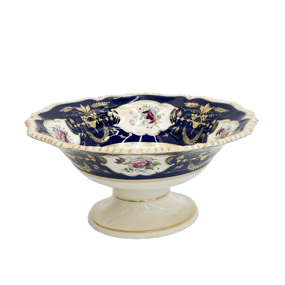 Royal Crown Derby Hand Painted Porcelain Centerpiece Compote Cobalt Blue c1820s: Royal Crown Derby Hand Painted Porcelain Centerpiece Compote. A cobalt blue ground to the edge, panels of colorful florals. Underside with Derby mark circa 1820s Weight: Approx. 3 lbs Measurements: Ap