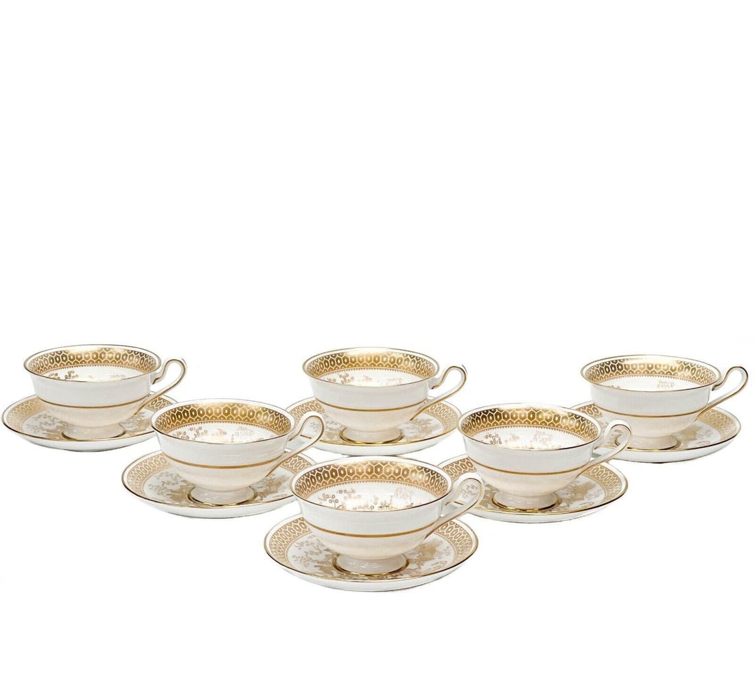 6 Spode England Gilt Porcelain Cup & Saucers in Spode's Garden Gold: 6 Spode England porcelain cup & saucers in Spode's Garden. A white ground with ornate gilt image to the center of figures fishing, geometric decoration to the edge. Gilt to the rim. Underside marked S