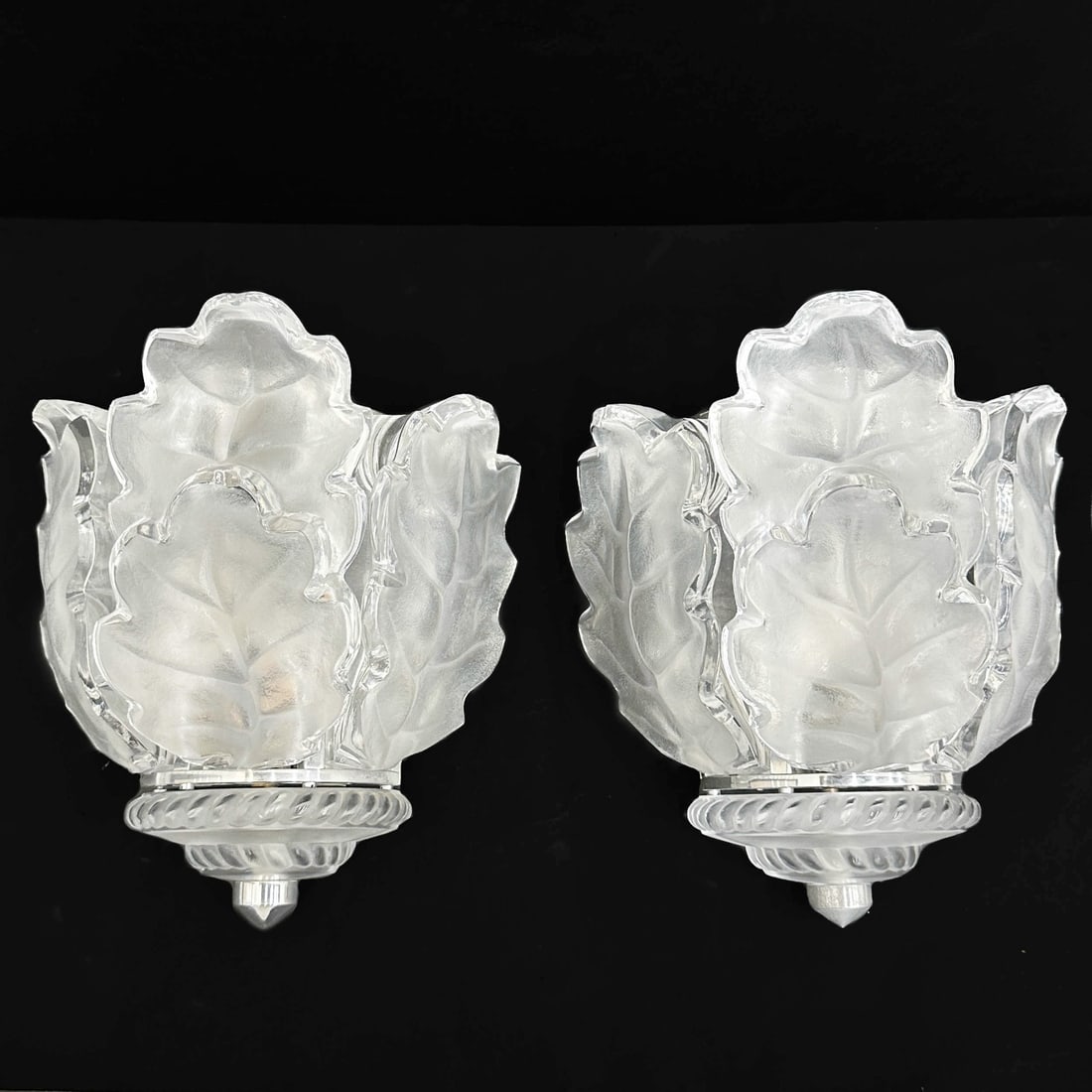 Pair Lalique France Art Glass Leaf Wall Sconces Chene by Marc Lalique: Pair Lalique France Art Glass Chene Wall Sconces. Leaf form wall sconces with chrome hardware. Designed by Marc Lalique. Glass marked Lalique France. Weight: Approx. 26 lbs Measurements: Approx. 9.5