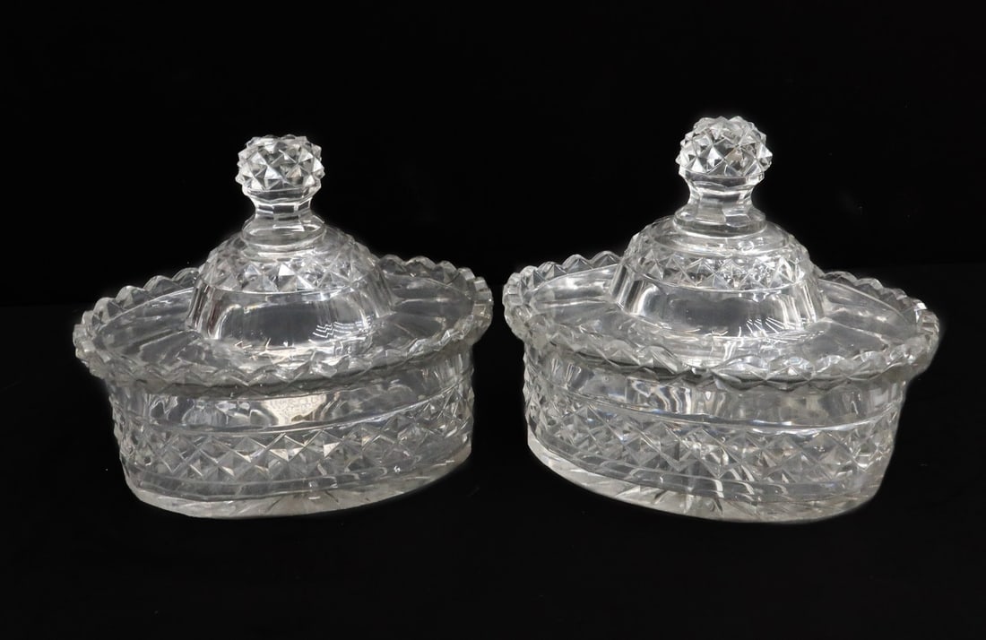 Pair English Cut Glass Scallop Rimmed Covered Oval Sauce Dishes 1st Half 19th C.: Pair English cut glass scallop rimmed covered oval sauce dishes, 1st Half 19th Century. Scallop rimmed with engraved diamond designs throughout. Starburst design to underside. Weight: Approx. 2 lbs