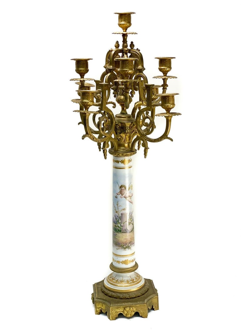 Sevres Style Porcelain & Gilt Bronze 10 Arm Candelabra: Sevres style porcelain & gilt bronze 10 arm candelabra, circa 1900. The stem of the candelabra depicts a hand painted cherub chasing a bird Artist signed. Foliate scroll arms to the lights. Weight App