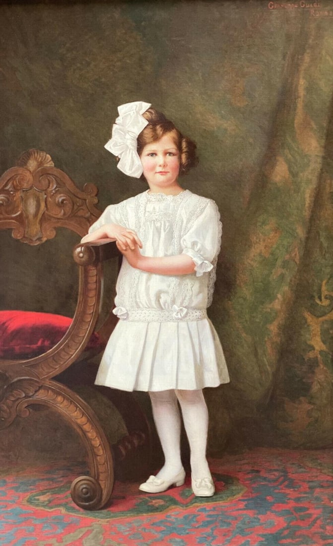 Giuseppe Guidi (Italian 1881-1931) Oil on Canvas Young Girl in White Dress, 1910: Giuseppe Guidi (Italian 1881-1931) oil on canvas, 1910. The painting depicts a young girl in a wearing a white dress and headband leaning against a chair against a draped backdrop. Artist signed "Gius