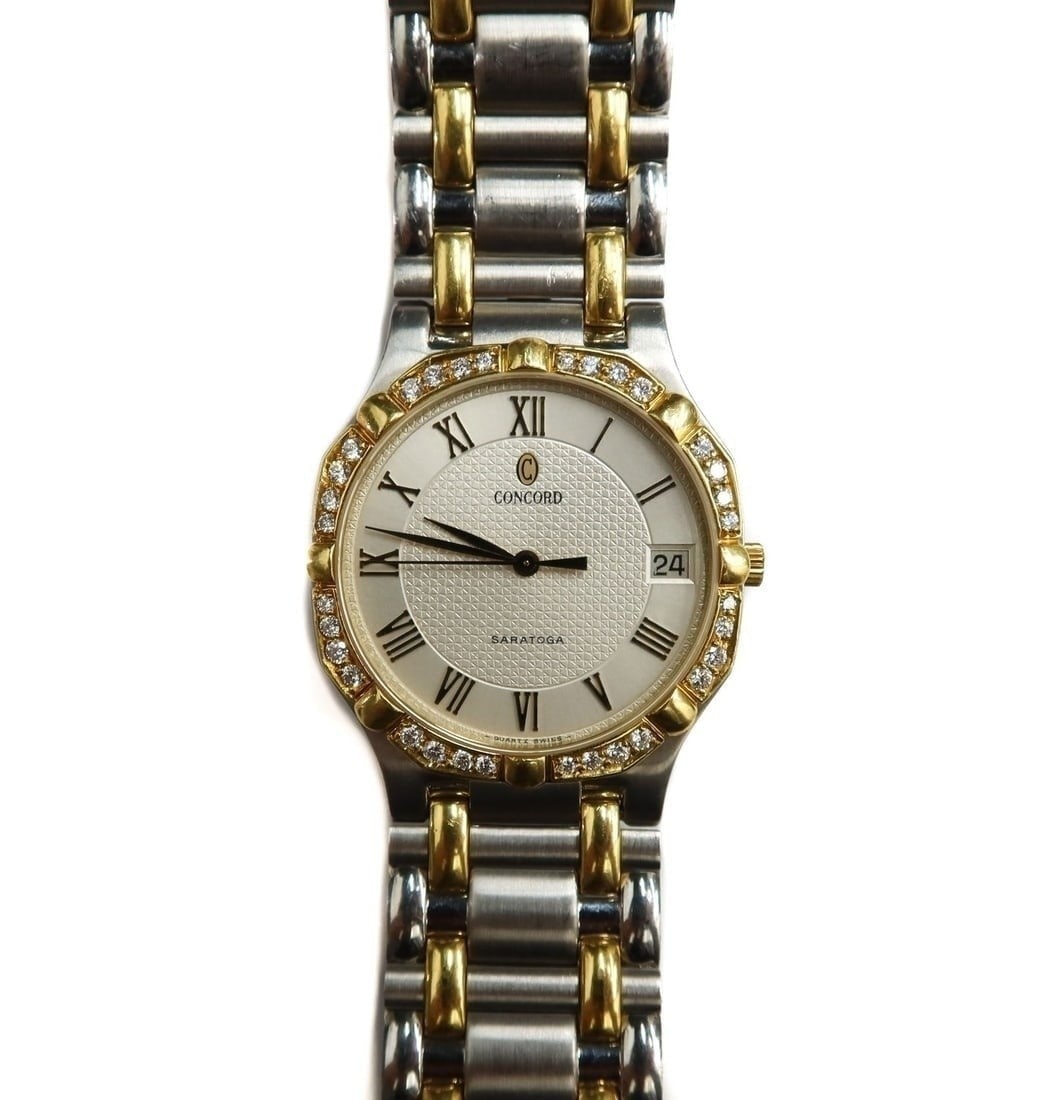 Concord Saratoga Diamond Encrusted Wrist Watch: Concord Saratoga Diamond Encrusted Water Resistant Wrist Watch. Stainless steel and 18k yellow gold with 32 round cut diamonds weighing approximately 0.53 carats. Weight Approx., 95 grams Measures App